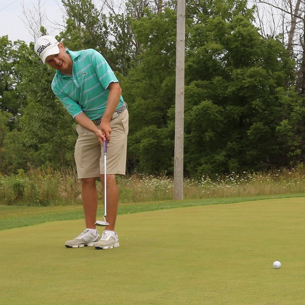 golfer practices on putting green at bruces mill conservation park driving range