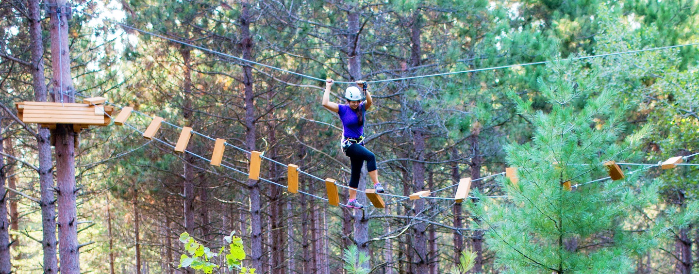 young woman on treetop trekking course at bruces mill conservation park