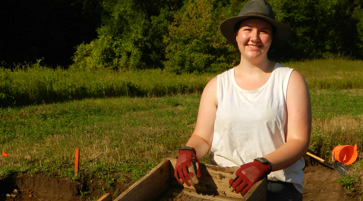 female Indigenous student works on a site excavation at the Boyd Archaeological Field School