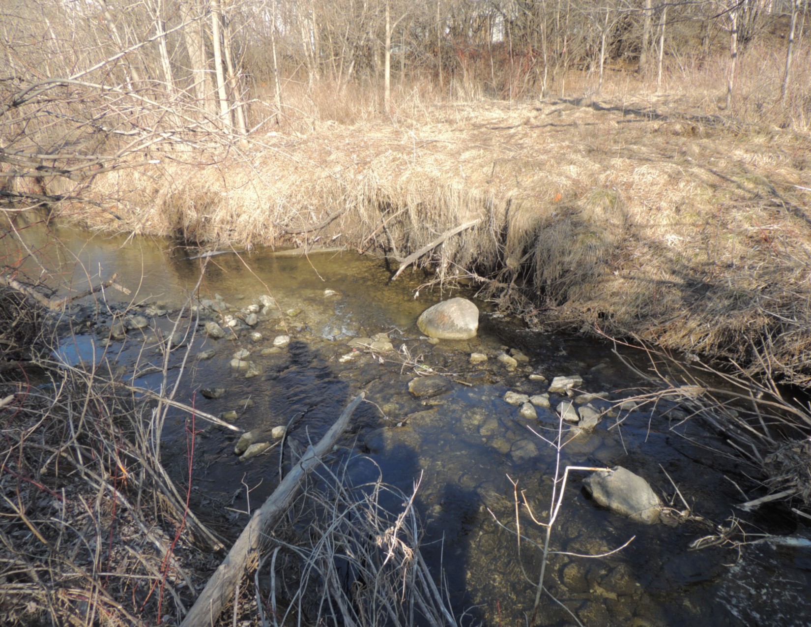 Erosion at Site I-070 where the sanitary line crosses the watercourse and is at risk of exposure.