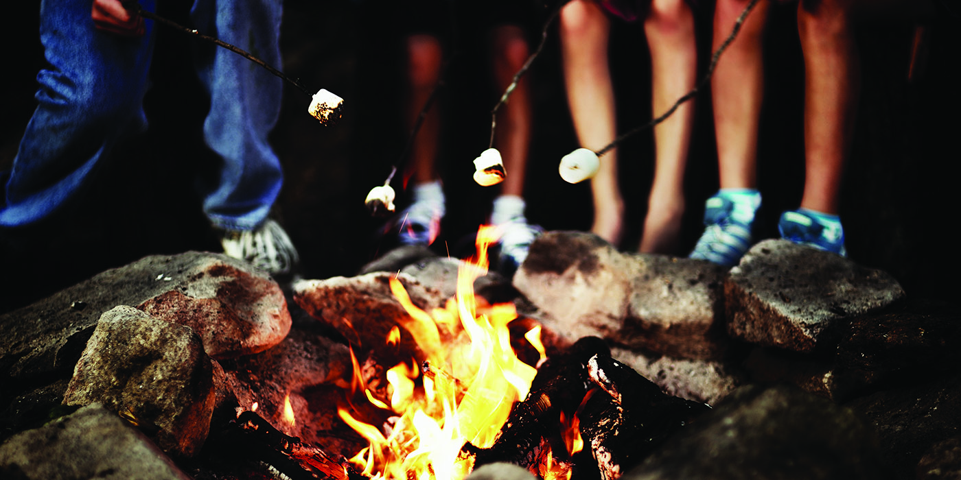 children roasting marshmallows over campfire