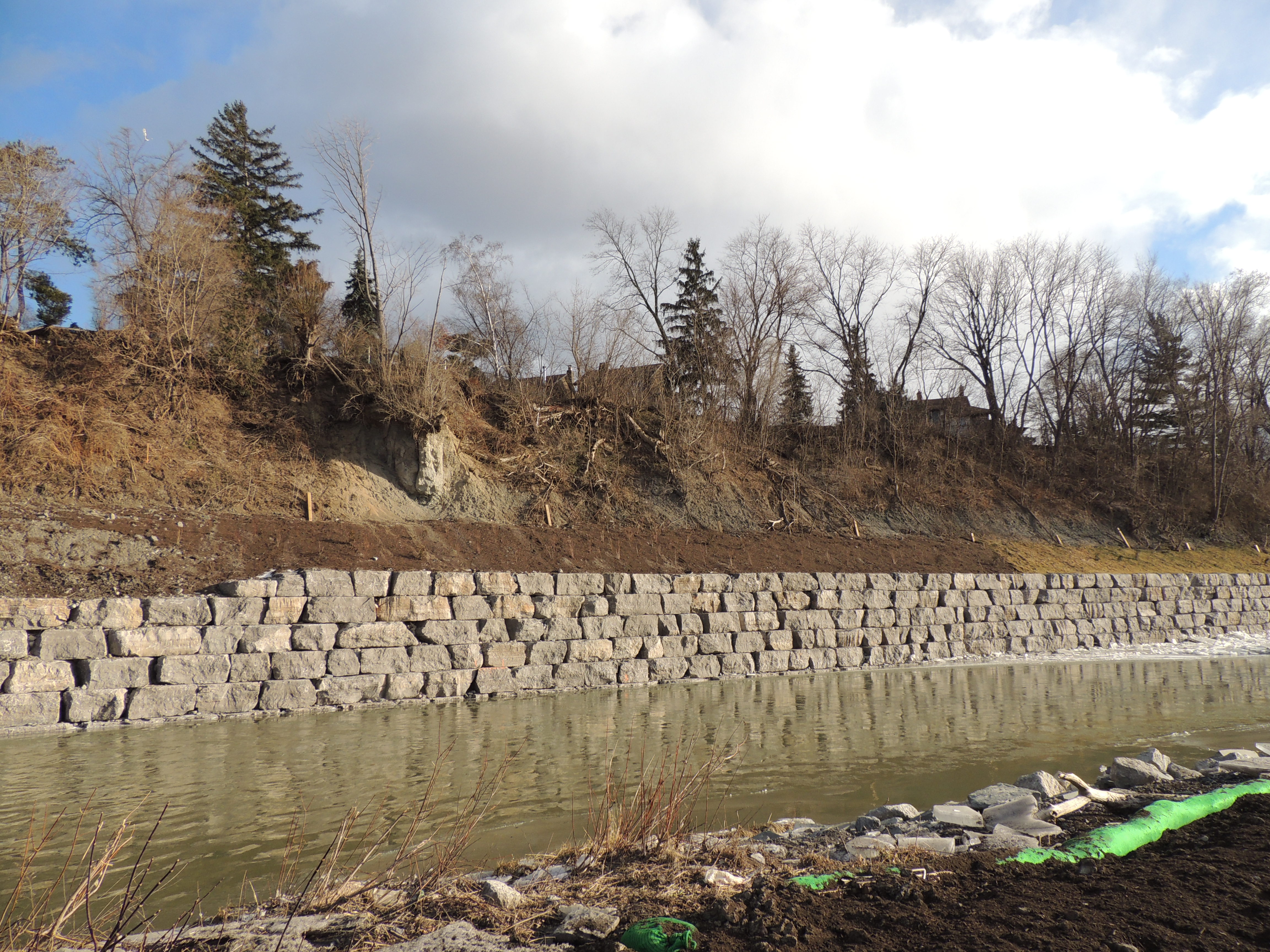 An armourstone wall and soil stabilization measures at the toe of a steep slope overlooking the Humber River