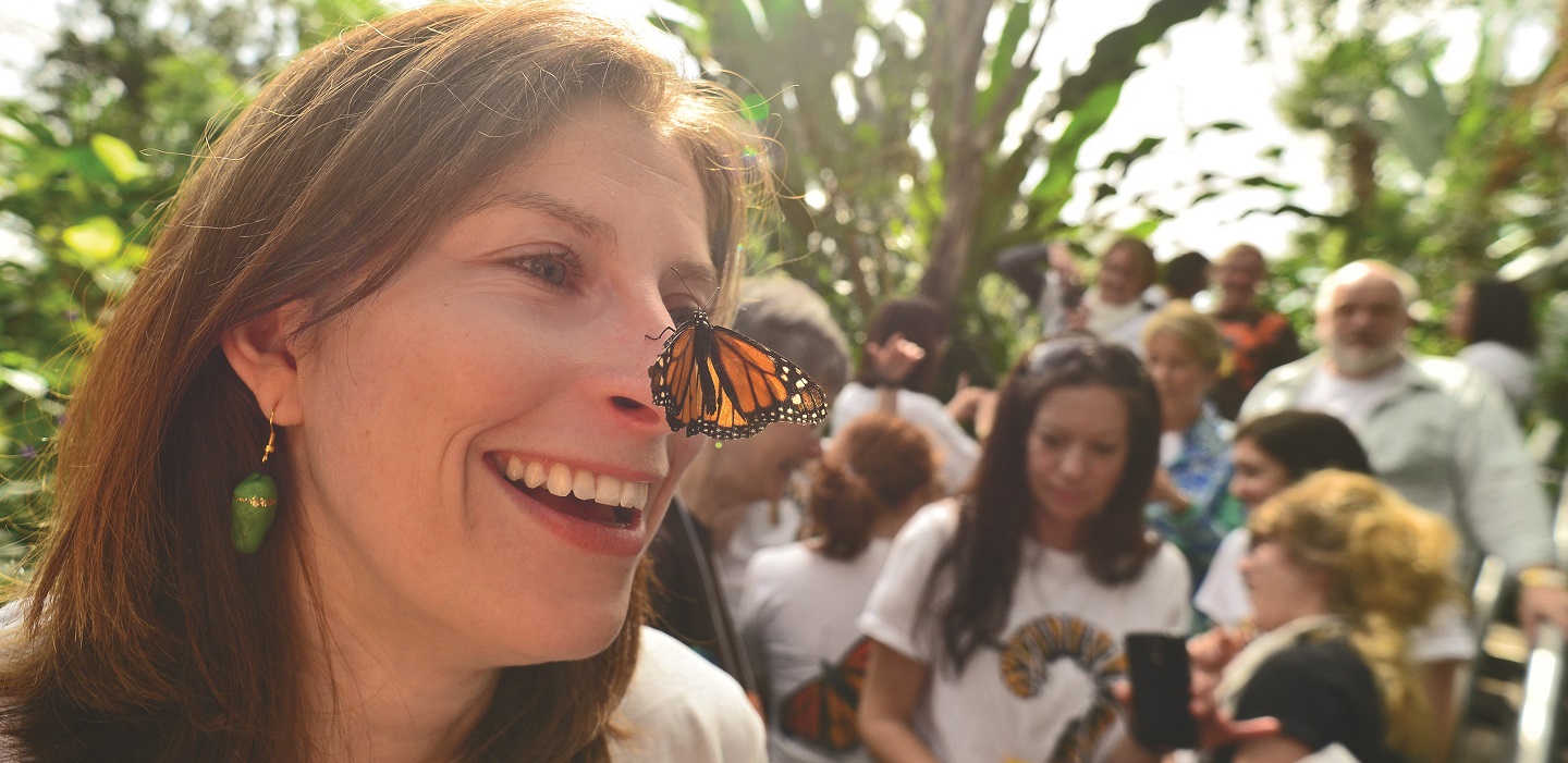 butterfly lands on woman's nose at Monarch Teacher Network event