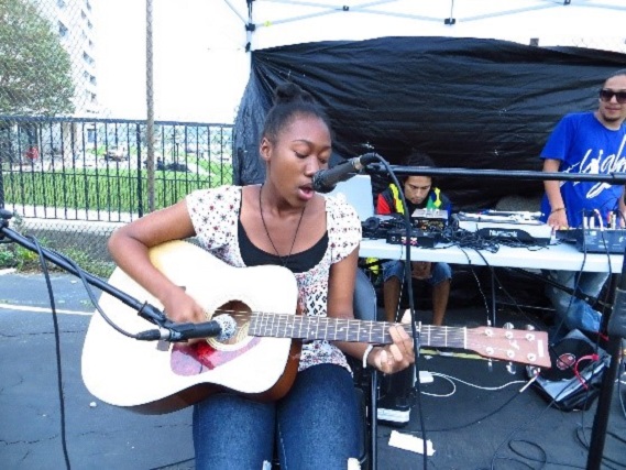 young musician performs at Black Creek SNAP pop-up park event for the San Romanoway Towers revival project in 2013